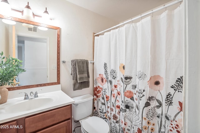 bathroom with a shower with curtain, vanity, and toilet