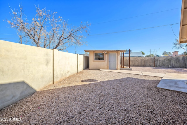 view of yard with an outdoor structure and a patio