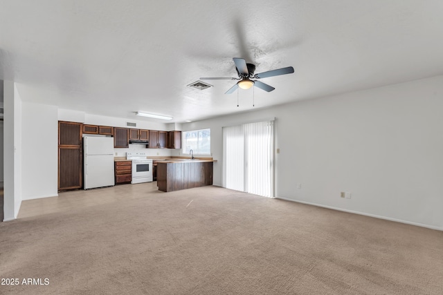 unfurnished living room with sink, light carpet, and ceiling fan