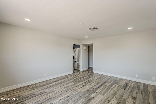 662 W Elena Ave, Mesa, AZ 85210 - spare room with light wood finished floors, recessed lighting, and baseboards