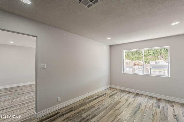 662 W Elena Ave, Mesa, AZ 85210 - unfurnished room featuring light wood finished floors, baseboards, recessed lighting, and a textured ceiling