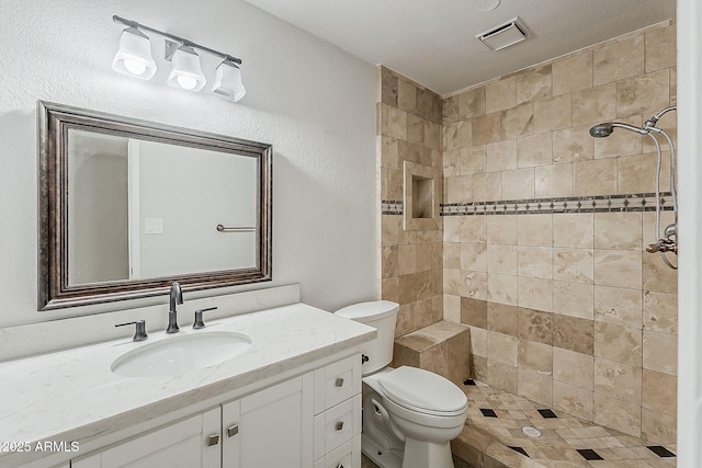 662 W Elena Ave, Mesa, AZ 85210 - bathroom featuring vanity, tiled shower, and toilet