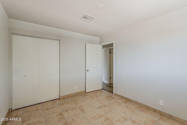 662 W Elena Ave, Mesa, AZ 85210 - unfurnished bedroom with a closet, light tile patterned floors, and baseboards