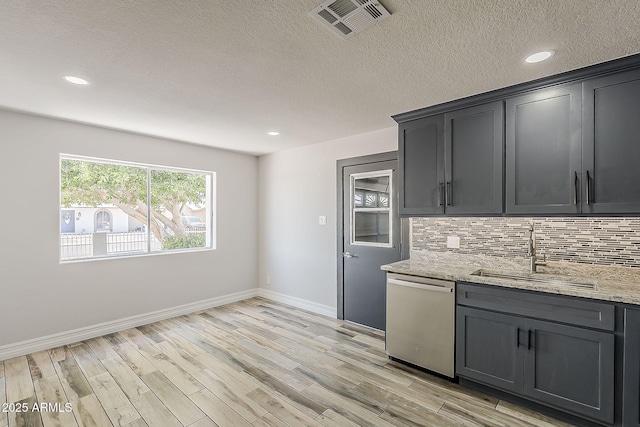 662 W Elena Ave, Mesa, AZ 85210 - kitchen with stainless steel dishwasher, a sink, backsplash, baseboards, and light wood-style flooring