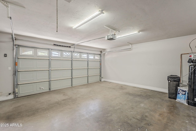 662 W Elena Ave, Mesa, AZ 85210 - garage with a garage door opener and baseboards