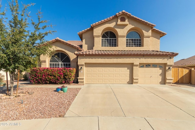 mediterranean / spanish-style home with a garage