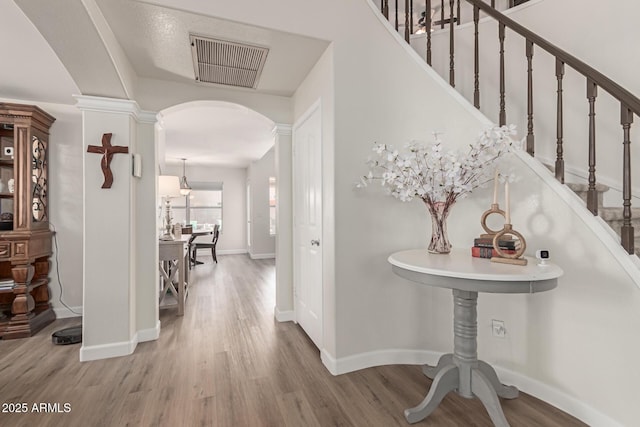 entrance foyer with wood-type flooring and decorative columns