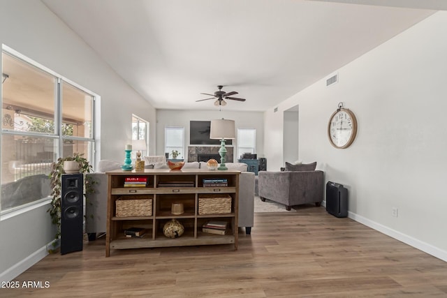 dining area with hardwood / wood-style flooring and ceiling fan