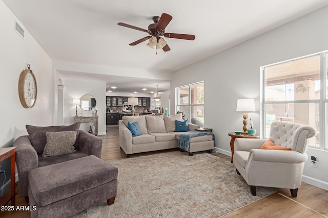 living room featuring ceiling fan and light wood-type flooring