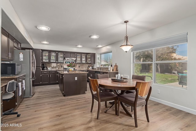 dining space with light hardwood / wood-style flooring