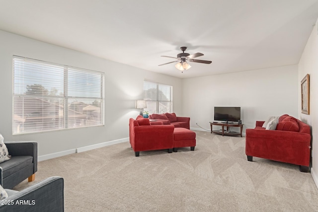 carpeted living room with ceiling fan