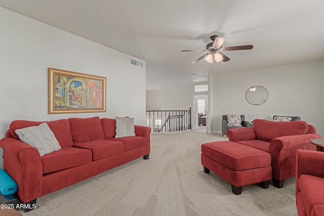 carpeted living room featuring ceiling fan