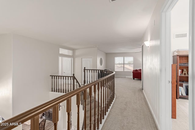 hallway with light colored carpet