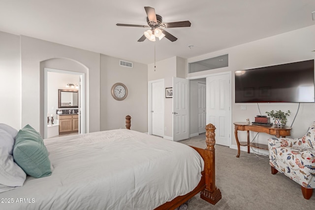 bedroom featuring connected bathroom, ceiling fan, and carpet flooring