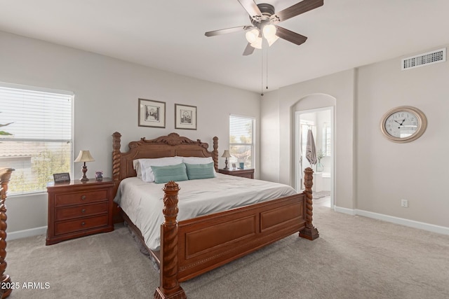 carpeted bedroom featuring connected bathroom and ceiling fan