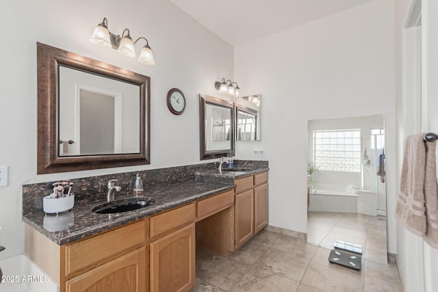 bathroom featuring tile patterned flooring, vanity, and a washtub