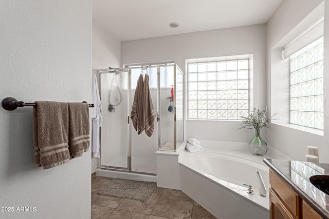 bathroom featuring vanity, tile patterned flooring, and shower with separate bathtub