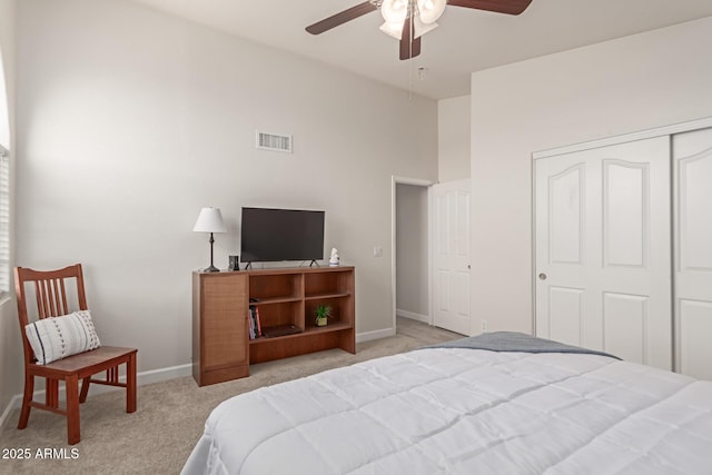 bedroom with light colored carpet, a closet, and ceiling fan