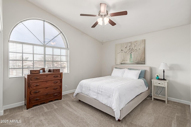 bedroom with lofted ceiling, light colored carpet, and ceiling fan