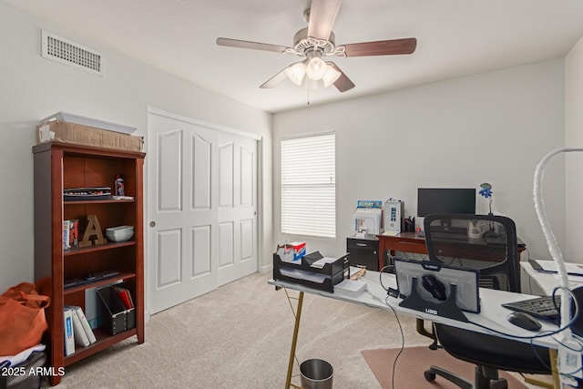 office area featuring light carpet and ceiling fan