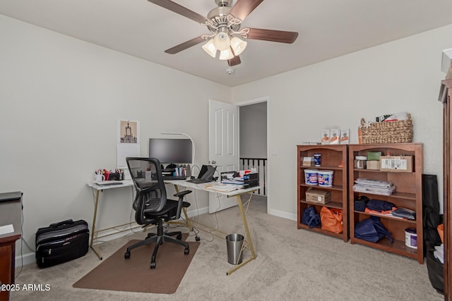 carpeted office featuring ceiling fan