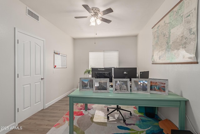 home office with wood-type flooring and ceiling fan