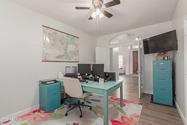 home office featuring wood-type flooring and ceiling fan