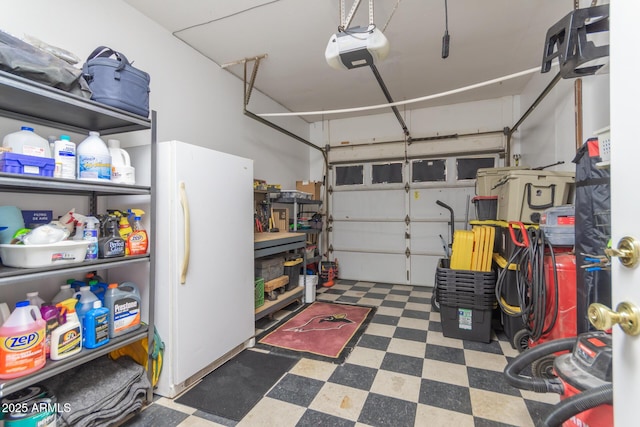 garage with a garage door opener and white refrigerator