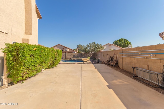 view of patio / terrace with a fenced in pool