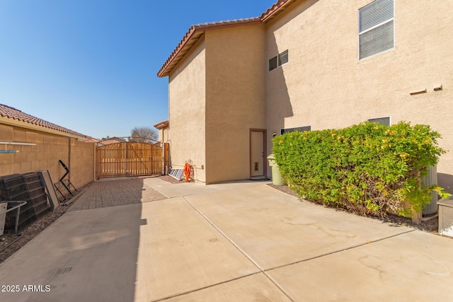 view of side of home with a patio area