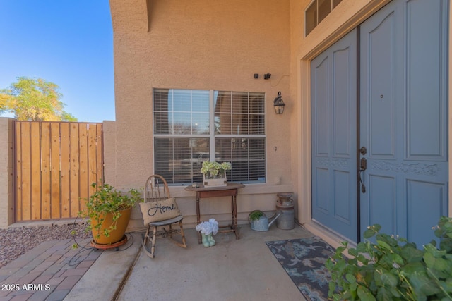 view of exterior entry featuring a patio area