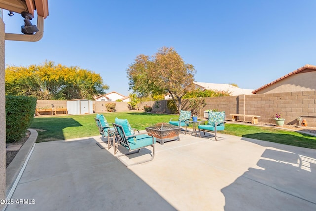 view of patio / terrace with a storage shed and an outdoor fire pit