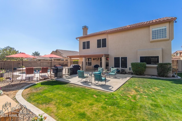 back of property featuring a yard and a patio