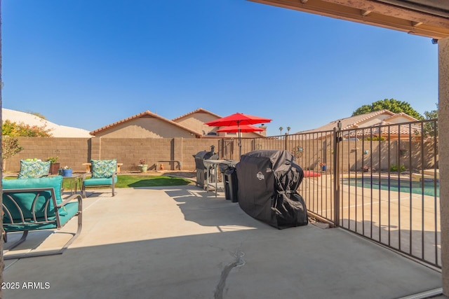 view of patio / terrace with area for grilling and a swimming pool