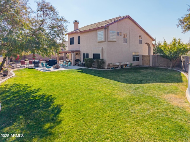 rear view of property with a patio and a lawn