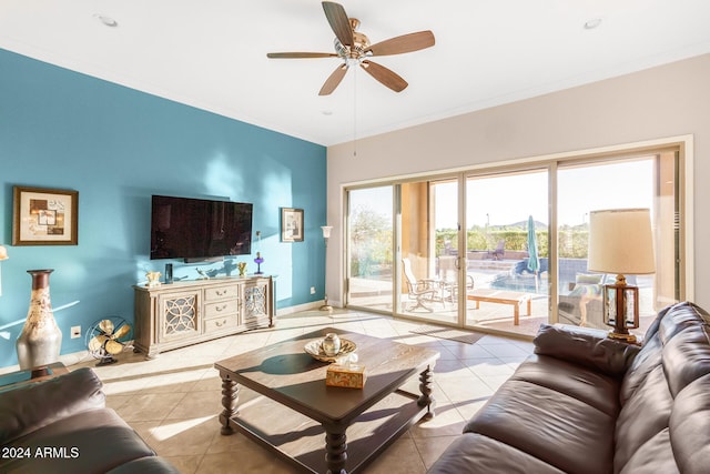 living room with ornamental molding, light tile patterned floors, and ceiling fan