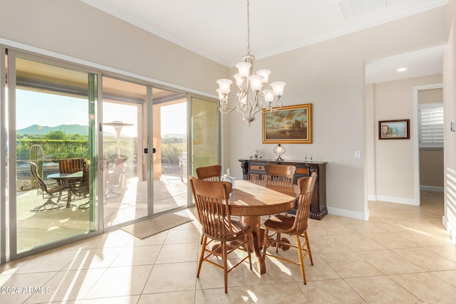 dining space featuring an inviting chandelier, a mountain view, light tile patterned floors, and crown molding