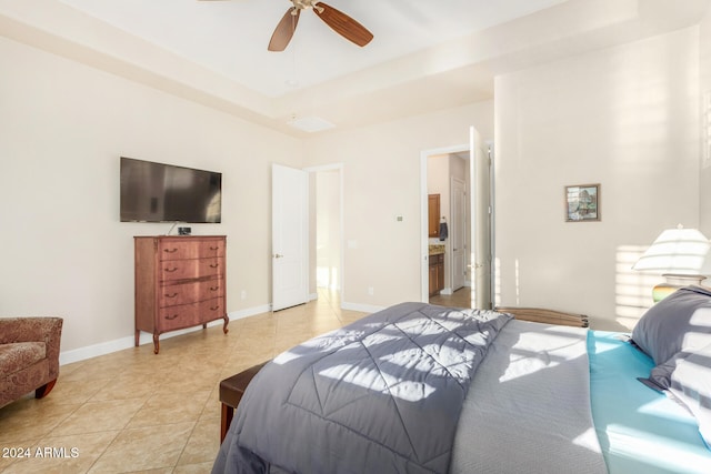 tiled bedroom featuring ceiling fan and a raised ceiling