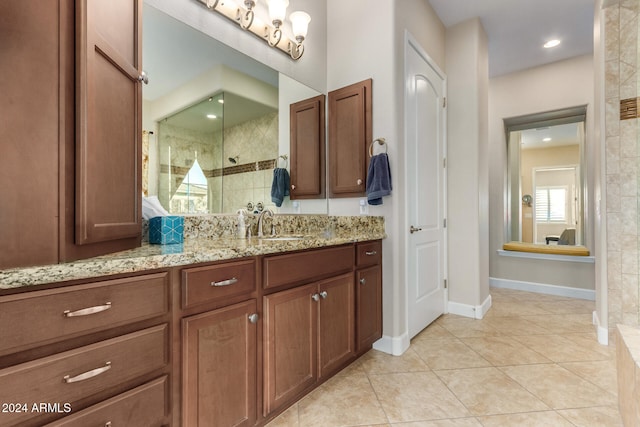 bathroom with vanity, tile patterned floors, and a tile shower