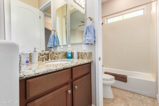 full bathroom with vanity, tile patterned flooring, toilet, and tiled shower / bath