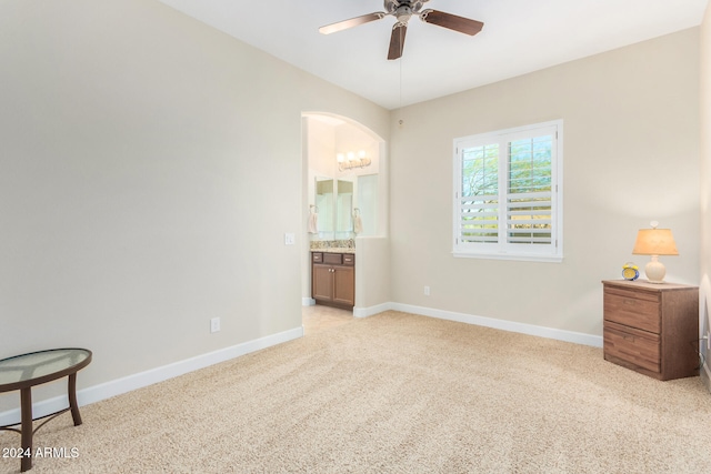 carpeted bedroom with connected bathroom and ceiling fan