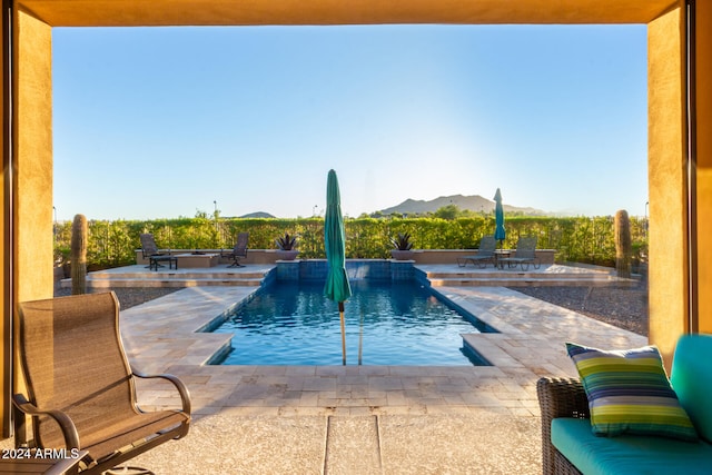 view of swimming pool with a mountain view, a patio, and pool water feature