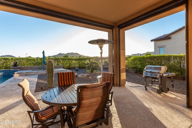 view of patio / terrace with a mountain view and grilling area