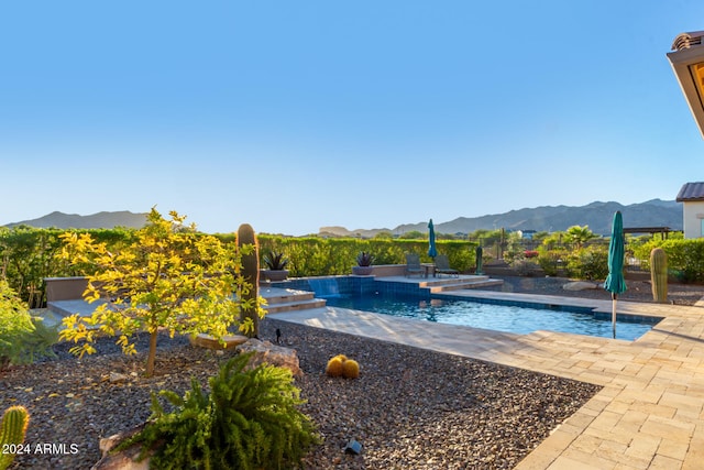 view of swimming pool featuring a mountain view and a patio area