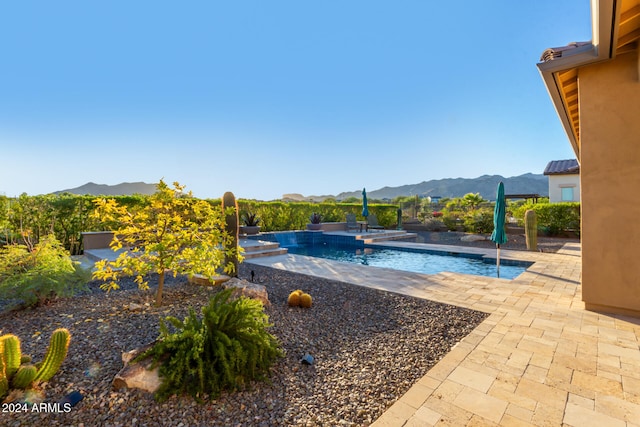 view of pool with a mountain view and a patio area