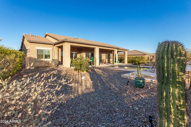 rear view of property featuring a patio area