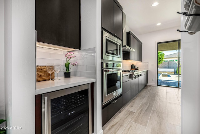 3822 E Canyon Pl, Chandler, AZ 85249 - kitchen with appliances with stainless steel finishes, wine cooler, modern cabinets, light countertops, and dark cabinets