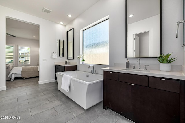 3822 E Canyon Pl, Chandler, AZ 85249 - full bath with a freestanding tub, two vanities, ensuite bathroom, and recessed lighting