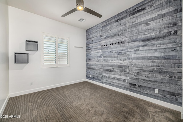 3822 E Canyon Pl, Chandler, AZ 85249 - empty room featuring carpet flooring, a ceiling fan, wood walls, and an accent wall