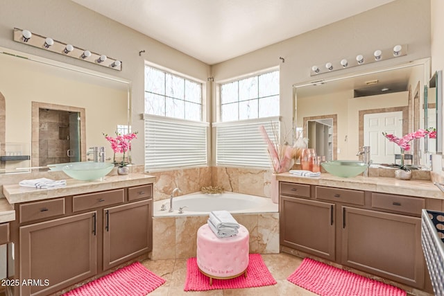 84 E Joseph Way, Gilbert, AZ 85295 - bathroom with two vanities, a garden tub, and tile patterned flooring